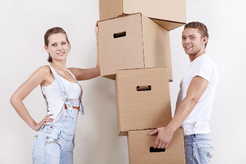 Professional movers carrying furniture during a house move in Kenley