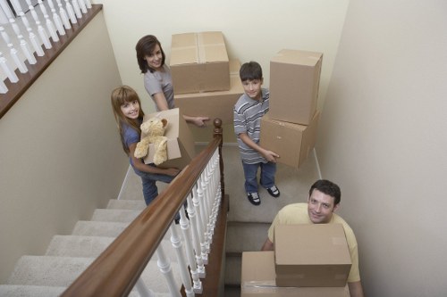 Packed boxes and furniture being loaded into a removals van